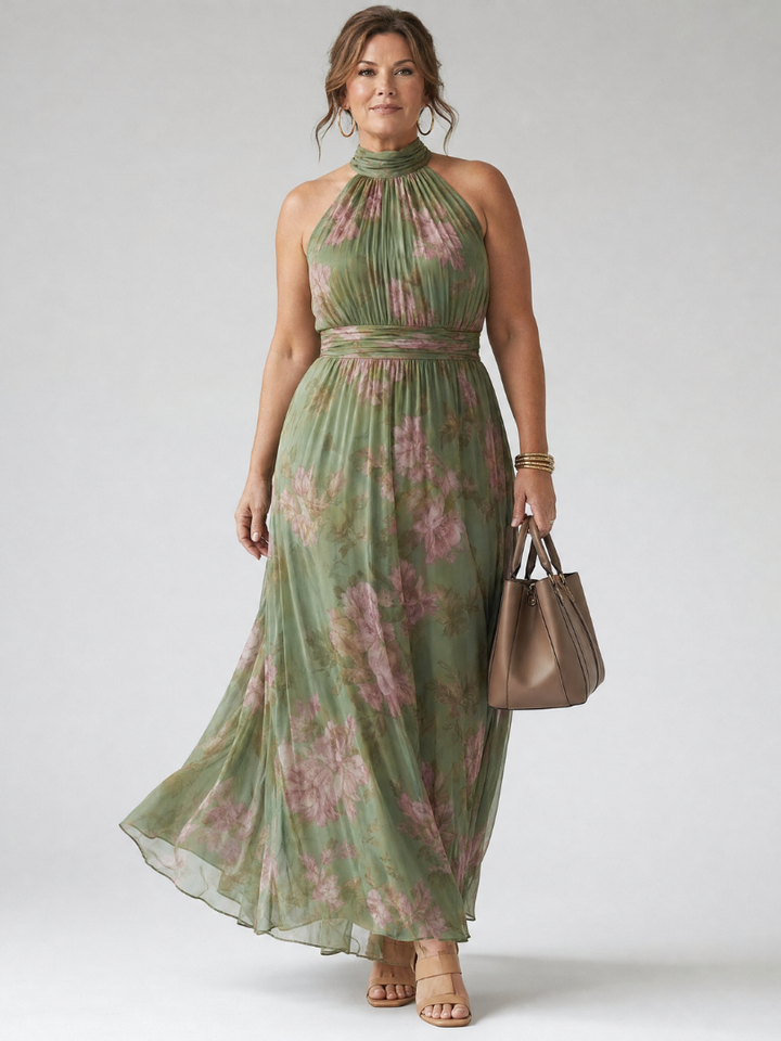 Flowing floral halter maxi dress styled with a tote bag