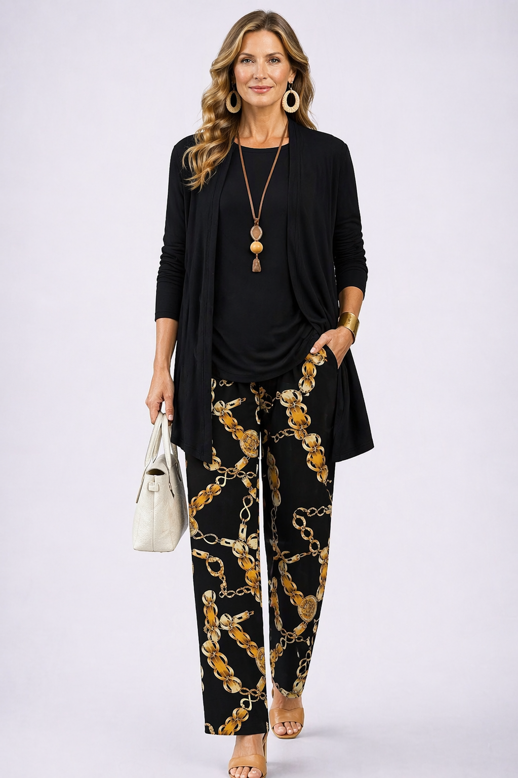 Women's black and gold open-front cardigan and chain print pant set