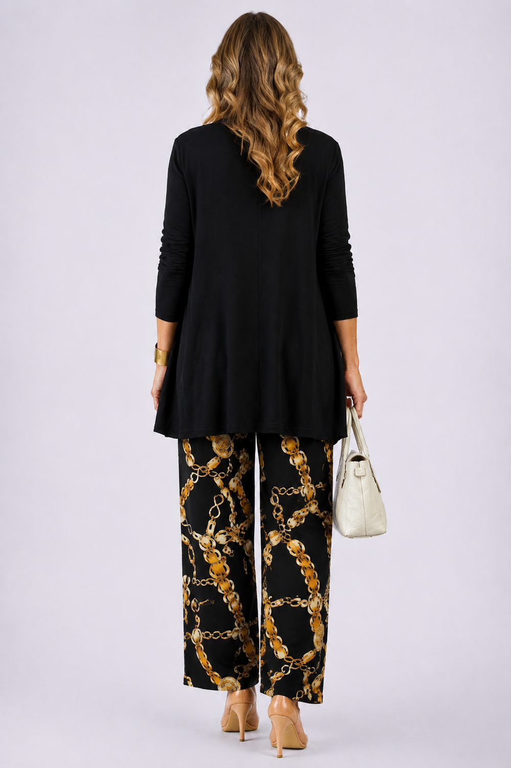 Back view of the black and gold open-front cardigan and chain print pant set