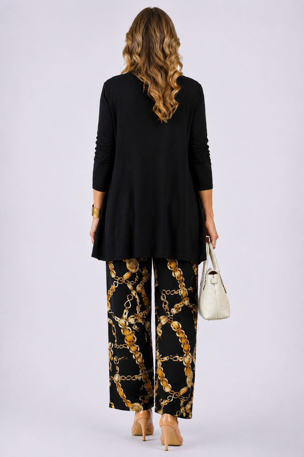 Back view of the black and gold open-front cardigan and chain print pant set