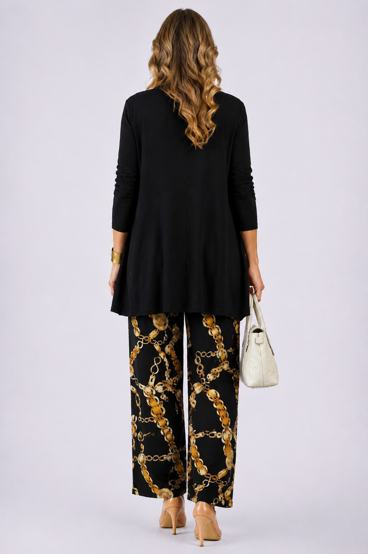 Back view of the black and gold open-front cardigan and chain print pant set