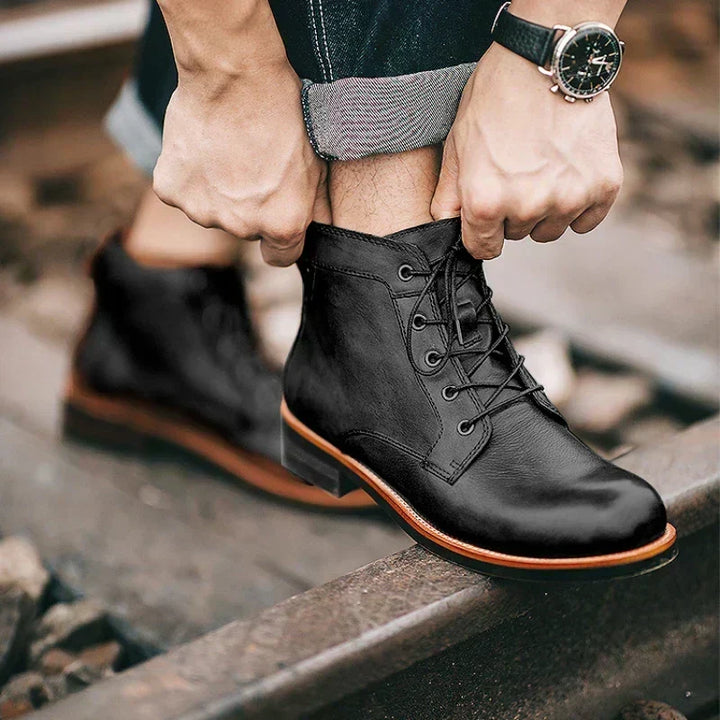 Black lace-up ankle boots worn with cuffed jeans