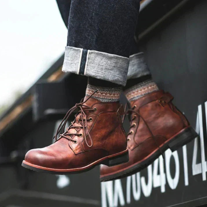 Brown men's ankle boots worn on a city outing