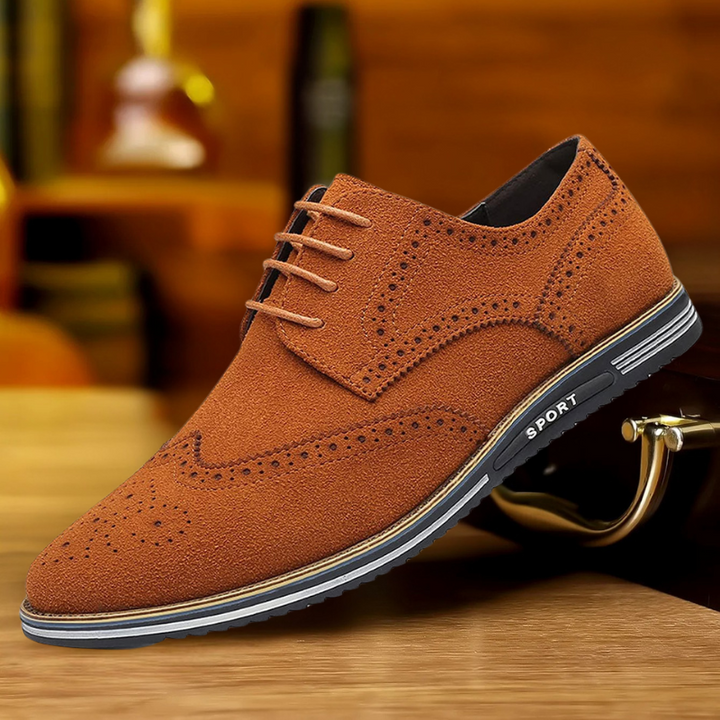 Black wingtip brogue shoe styled on a wooden surface