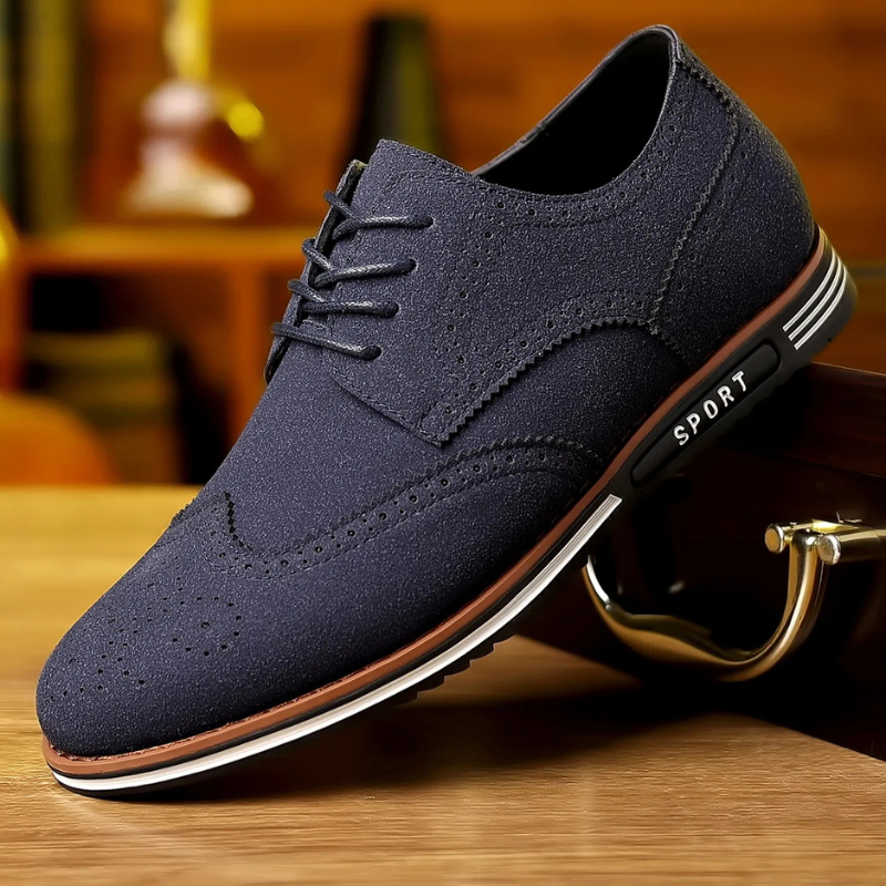 Brown wingtip brogue shoe styled on a wooden surface