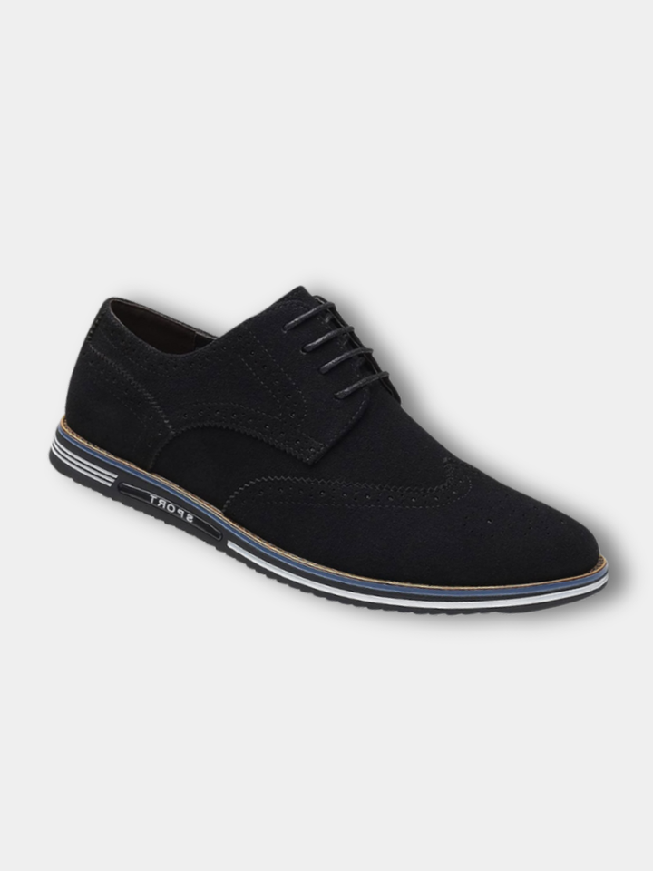 Navy wingtip brogues worn with jeans