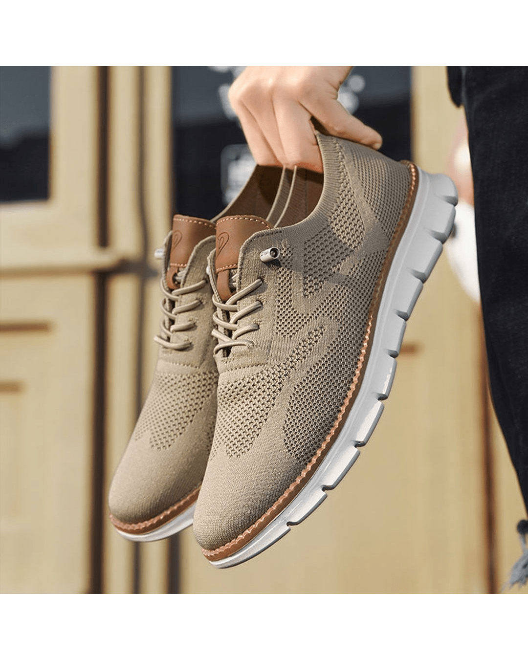 Taupe knit sneakers held in hand