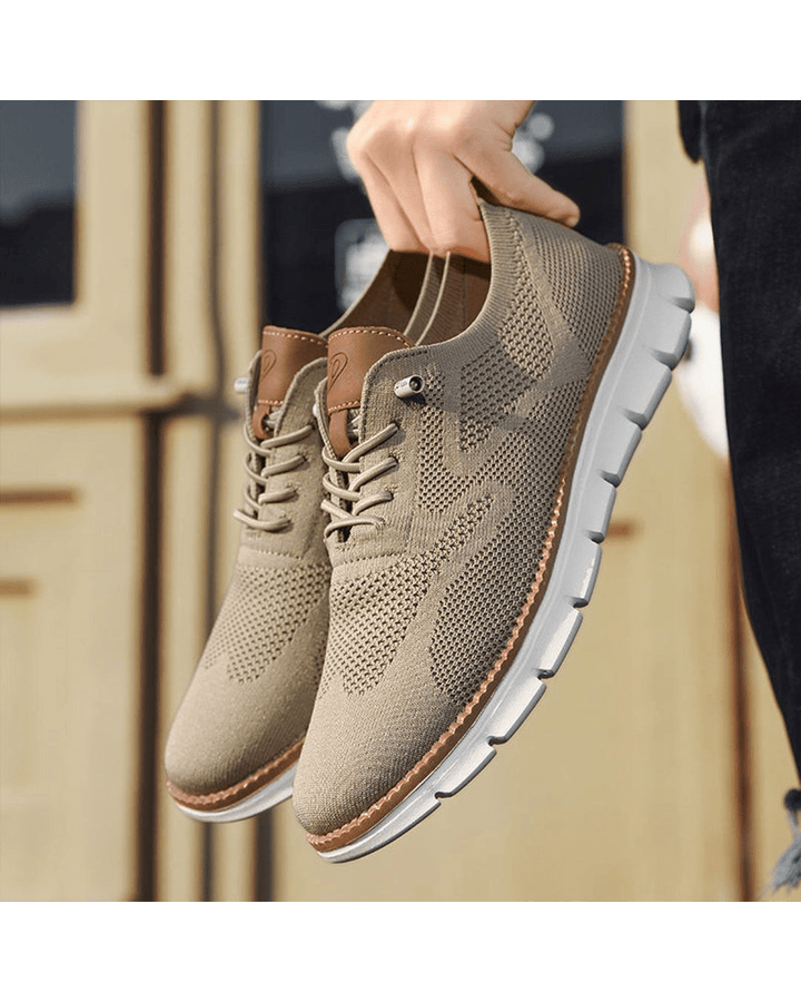 Taupe knit sneakers held in hand