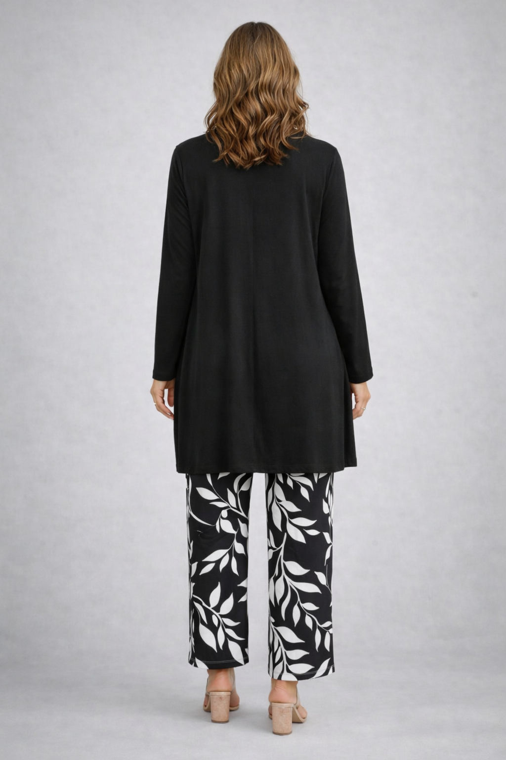 Back view of the black and white open-front cardigan and leaf print pant set