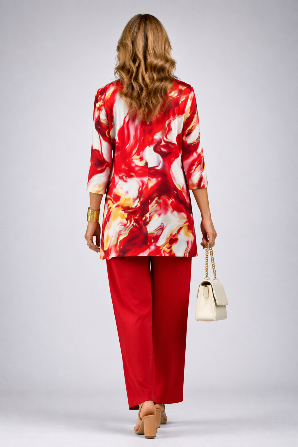 Back view of the red abstract print cardigan and pant set