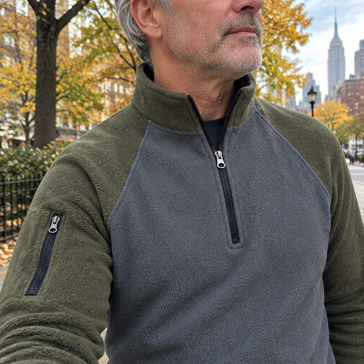 Close-up of the stand-up zip collar and sleeve pocket