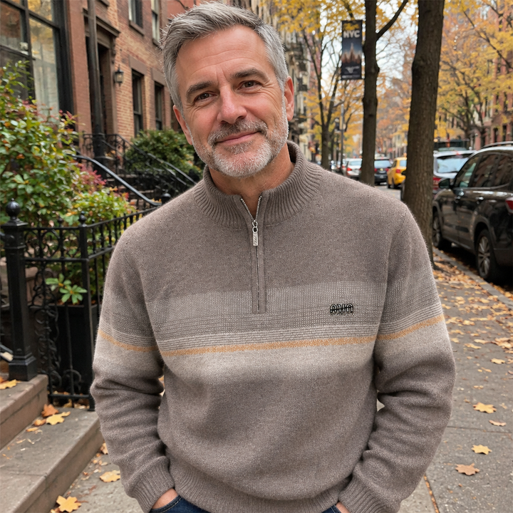 Man wearing a taupe half-zip sweater on a fall city street